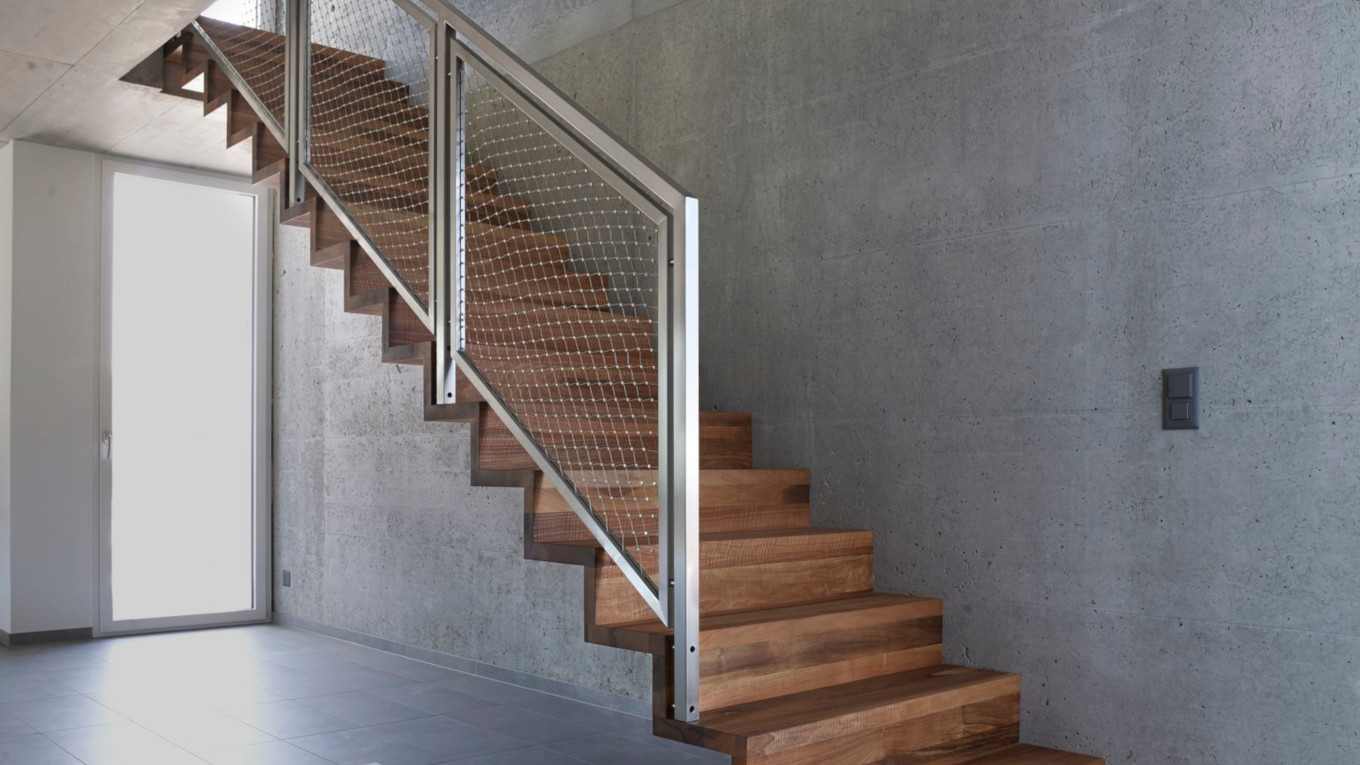 stainless steel safety railing on wooden stairs